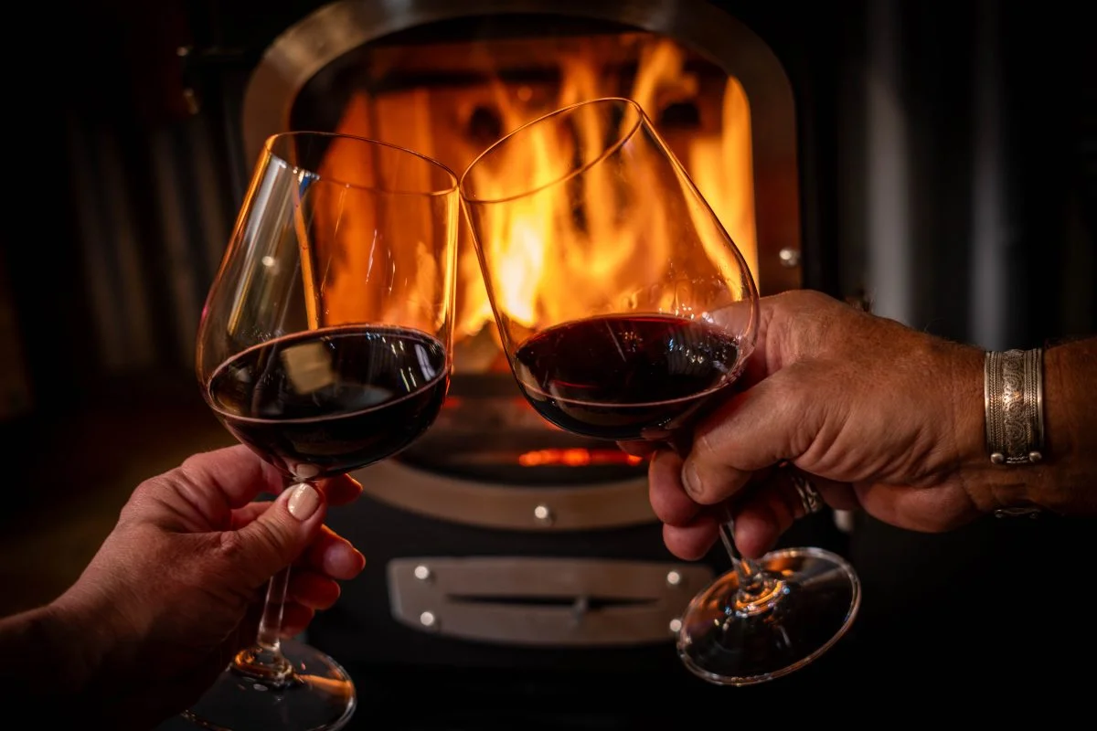A glass of wine in front of the Wood Burner - Glamping Cabin Carmarthenshire with Hot Tub