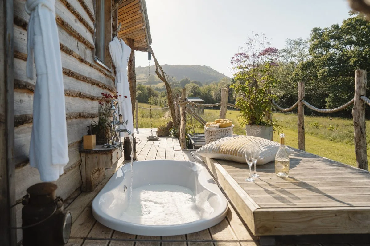 Relaxing outdoor bath at Sunset - Luxury Glamping Cabin Carmarthenshire, West Wales -