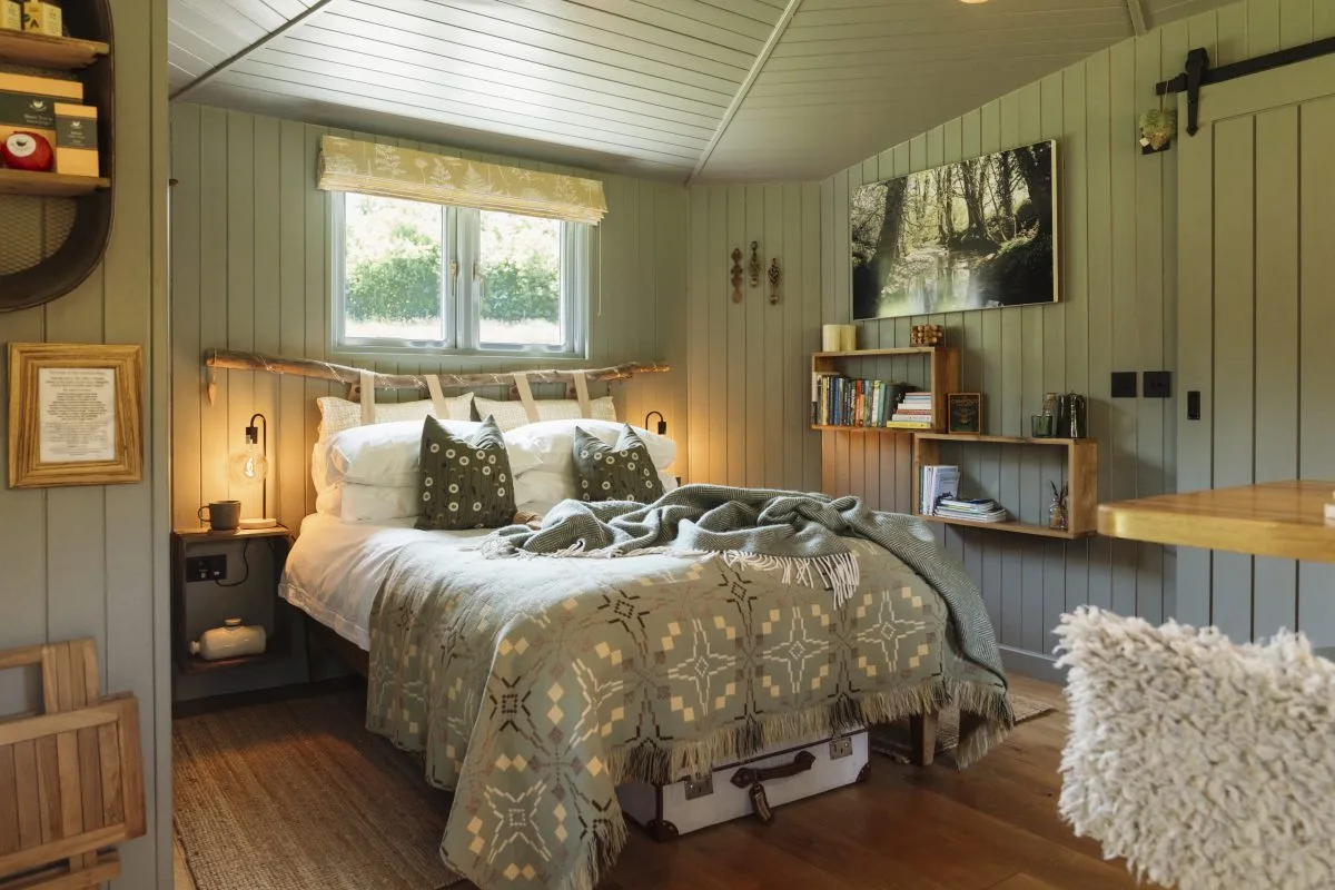 Cosy bed dressed with Egyptian Cotton Linens and Welsh Blankets - Luxury Glamping Cabin Carmarthenshire, West Wales