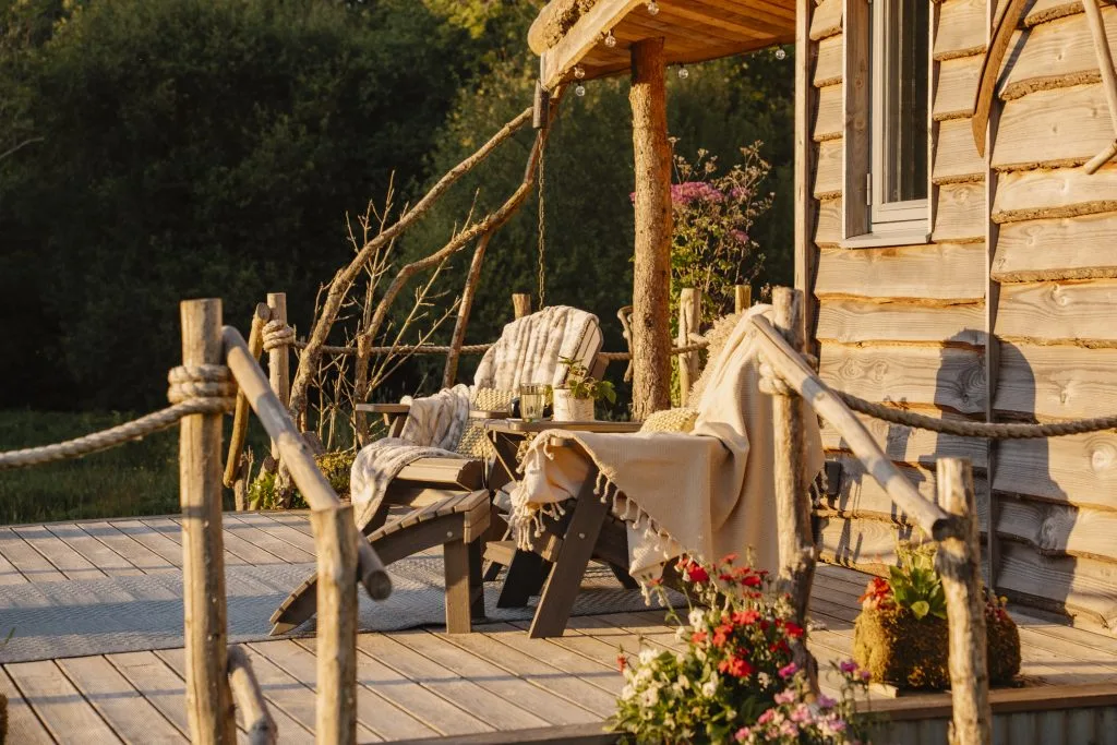 Golden Hour on the decking with views of the surrounding meadow -Luxury Glamping Cabin Carmarthenshire, West Wales 