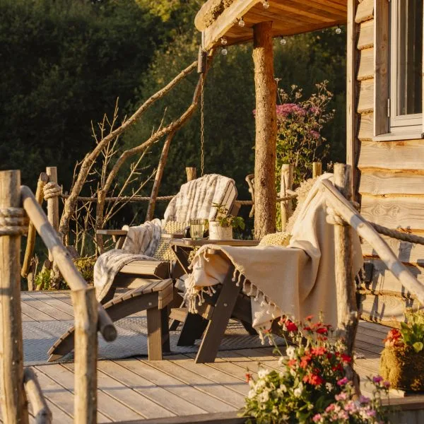 Golden Hour on the decking with views of the surrounding meadow -Luxury Glamping Cabin Carmarthenshire, West Wales