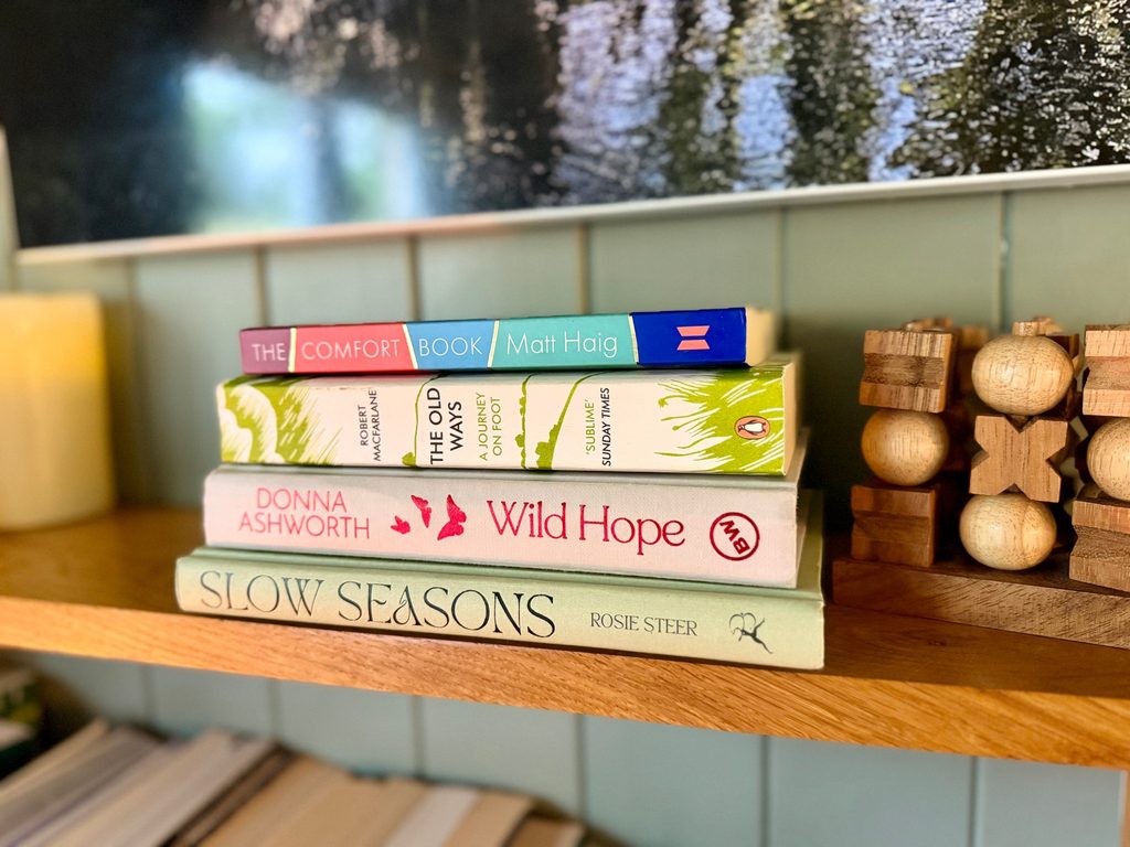 Selection of books on the shelf available to read in the cabin - Luxury Glamping, Carmarthenshire near Brecon Beacons